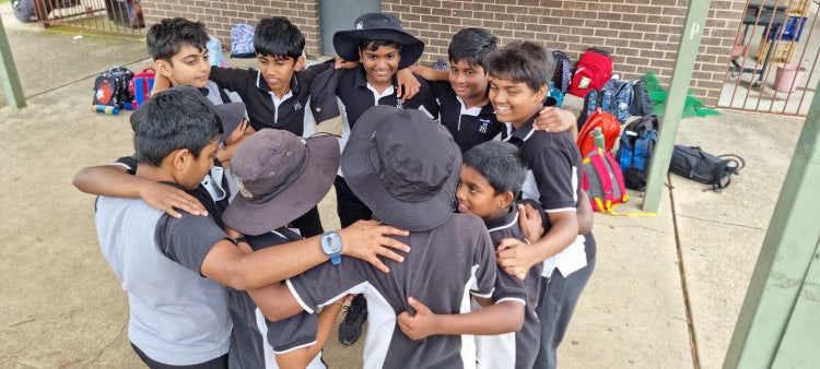group of male students in a huddle