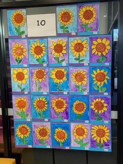 Display of student artwork depicting flowers