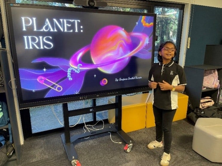Female student standing in front of a presentation board depicting a planet