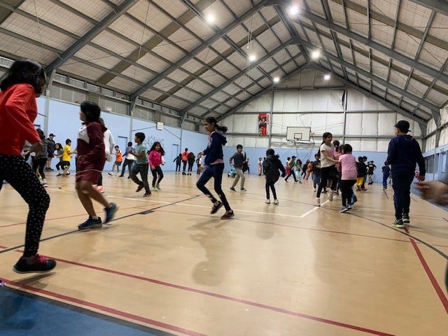 Students in indoor gym dancing