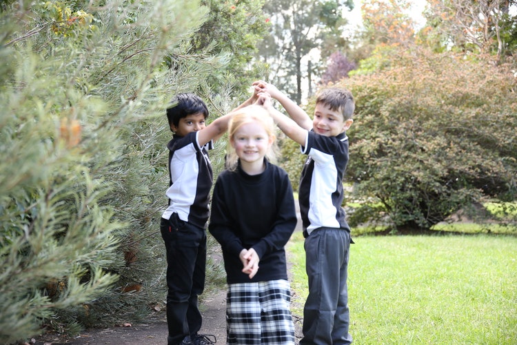Two male and one female student outside