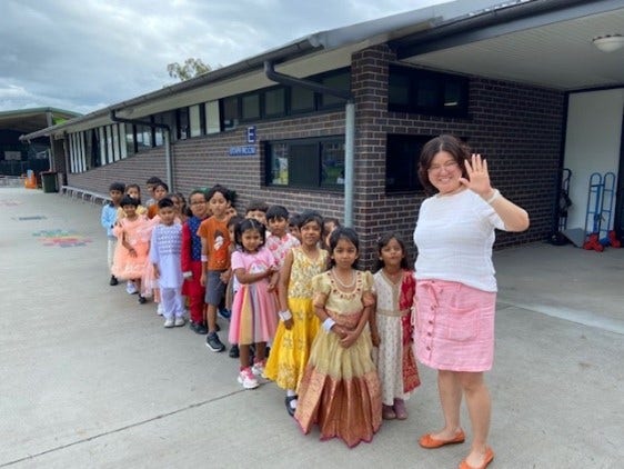 students dressed colourfully with their teacher