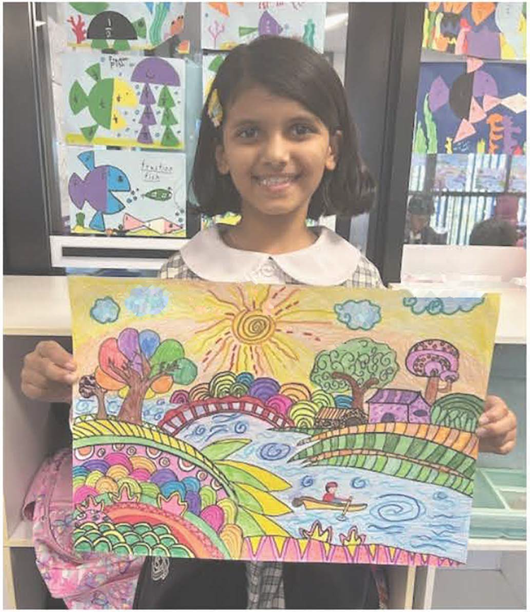 female student holding artwork