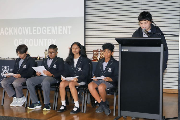 Student leadership team on stage in assembly