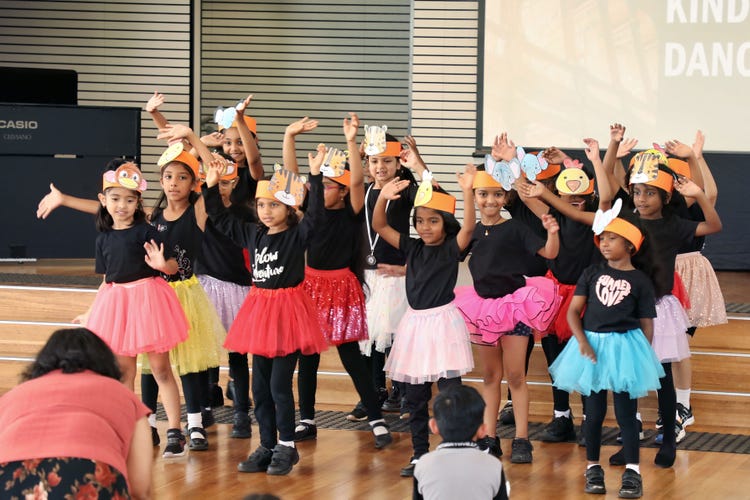 Students dressed colourfully and dancing